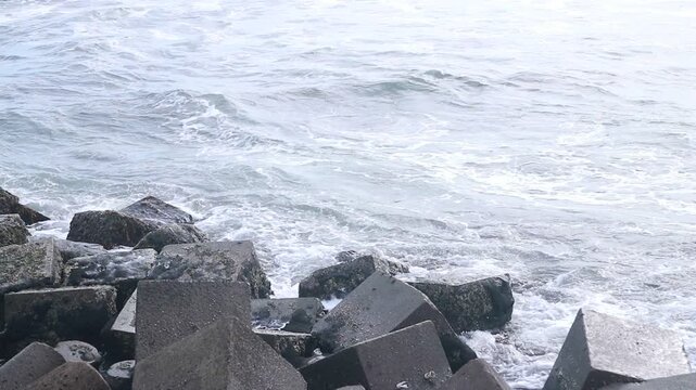 Concrete sea breakwaters that form a coastal breakwater protection at Glagah Beach, Yogyakarta.