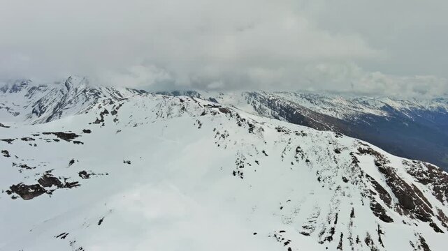 Aerial view of snow mountain range landscape with clouds. Alps mountains, Austria, 4k