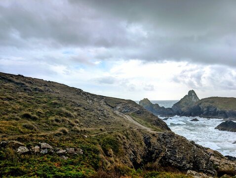 Coastal cliff path overlooking rocky ocean bay wilderness exploration