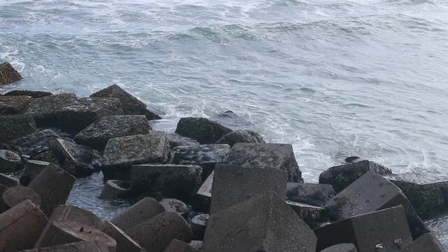 Concrete sea breakwaters that form a coastal breakwater protection at Glagah Beach, Yogyakarta.