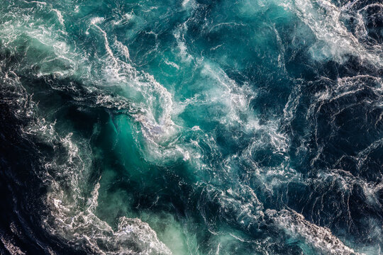 Blue waves of water of the river and the sea meet each other during high tide and low tide.