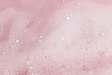 Fototapeta premium Beautiful abstract soapy texture background with white foam bubbles. Texture of shower gel, shampoo, detergent. small transparent bubbles. top view.