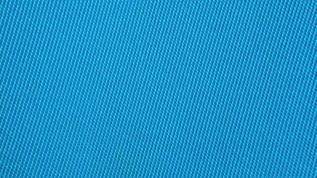 Close-up view of vivid blue woven fabric with intricate diagonal pattern, ideal for background, design projects, or textile visual content.