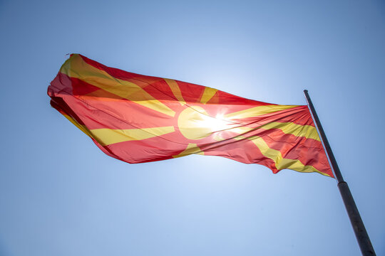 Low angle view of the North Macedonian Flag on a flagpole blowing in the wind on a summer day, Ohrid, North Macedonia