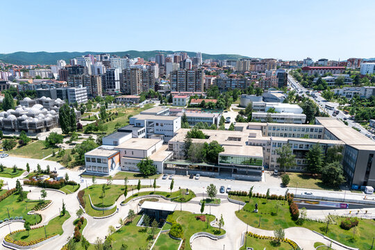 Aerial view of a University campus and city skyline with mountain backdrop, Pristina, Kosovo