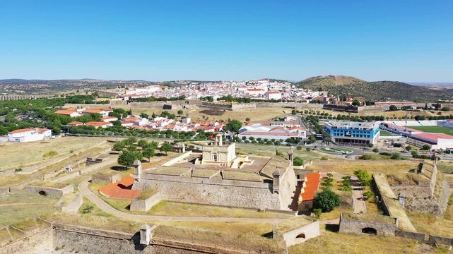 Aerial view of Forte de Santa Luzia with the city of Elvas and surrounding landscape under a clear blue sky in Portugal.