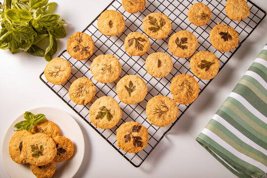 Herb-infused parmesan shortbread cookies on cooling rack