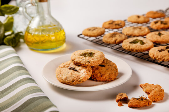 Savory herb and parmesan cookies on white plate