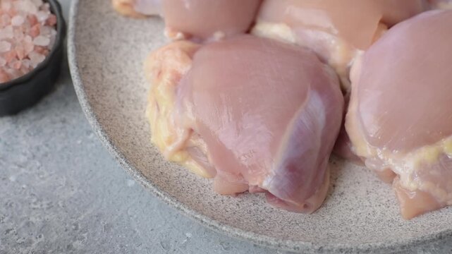 Raw chicken thigh fillet, boneless and skinless, for roasting. Raw thigh fillet as a food background for your design
