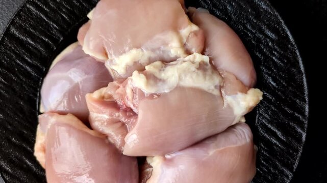 Raw chicken thigh fillet, boneless and skinless, for roasting. Raw thigh fillet as a food background for your design