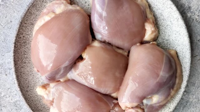 Raw chicken thigh fillet, boneless and skinless, for roasting. Raw thigh fillet as a food background for your design