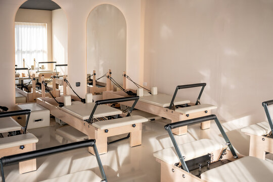 Pilates reformer equipment in bright modern fitness studio