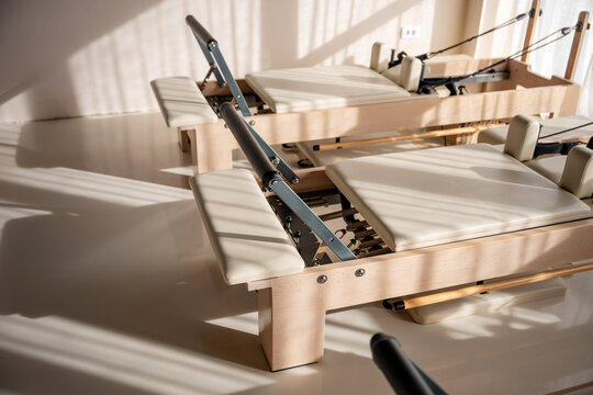 Bright Pilates reformers in a sunlit studio
