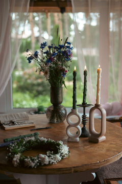 Rustic midsummer solstice table with candles and wildflowers