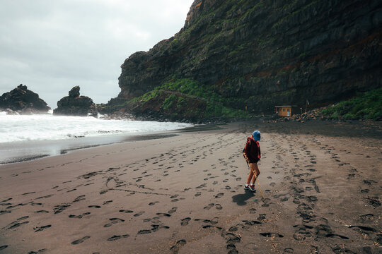 Dramatic black sand beach under cliffs at Playa de los Nogales