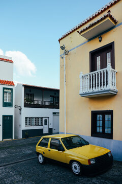 Colorful street scene with yellow car in San Andres