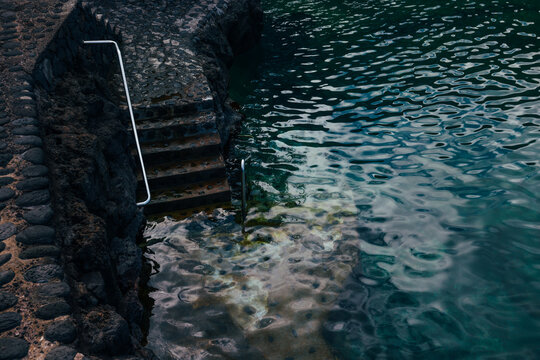 Coastal lava rock steps into Atlantic water, La Palma