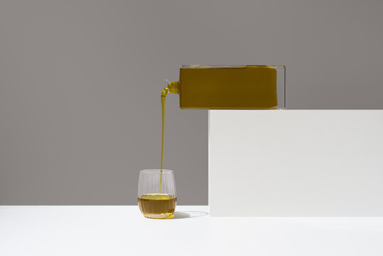 Minimal still life of olive oil pour for tasting and cooking