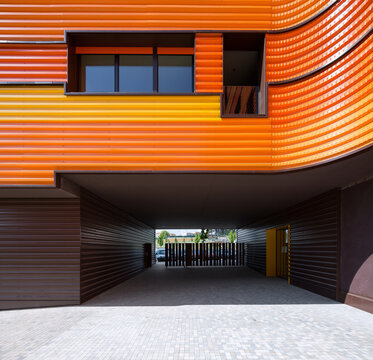Modern architecture with orange facade and open entryway