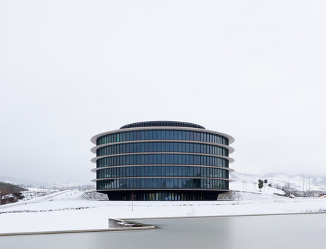 Modern circular office building in snowy landscape
