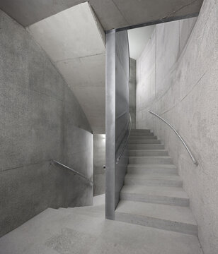 Minimal concrete stairwell inside modern office building