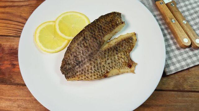 Grilled gilthead fillet on skin served on a white plate