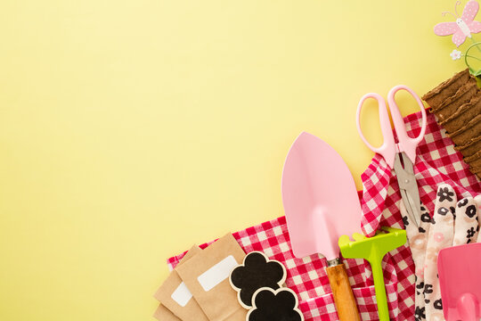 Gardening tools and supplies on yellow background, flat lay