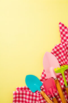 Yellow background with colorful gardening tools and towel
