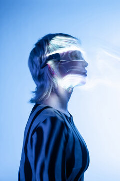 Young woman immersed in futuristic metaverse landscape