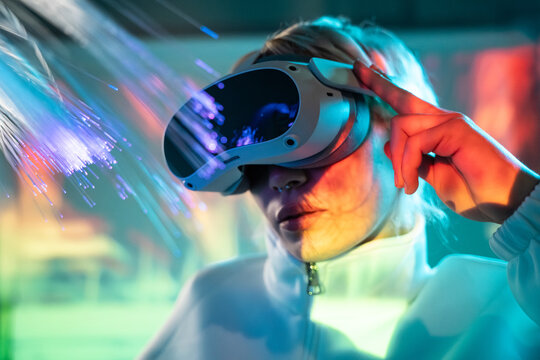 Young woman explores the metaverse with VR headset