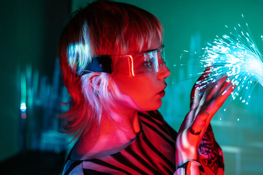 Young woman exploring the metaverse with fiber optics