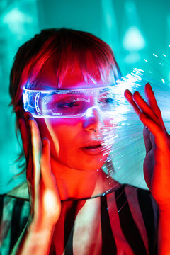Young woman in futuristic metaverse scene with optics