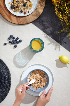 Top view of breakfast cereal with blueberries and juice