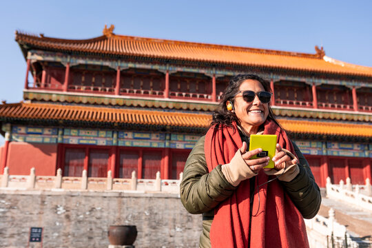 Woman using audio guide in Beijing, China