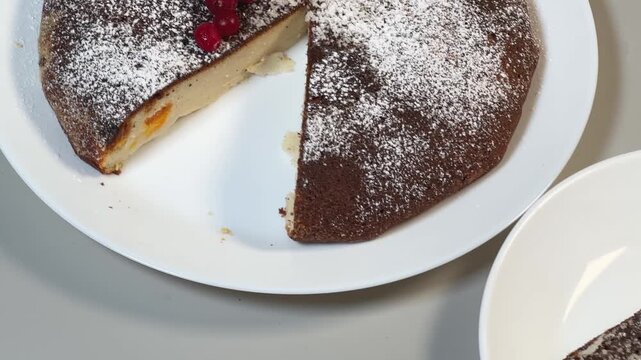 Sweet cottage cheese casserole and cut piece separately on plates