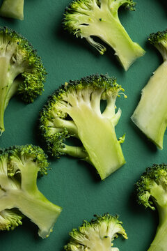 Fresh broccoli florets pattern on green background