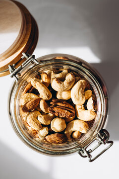 Assorted nuts in a glass jar with open lid