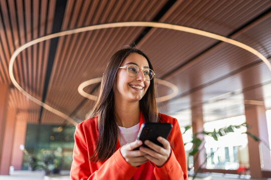 Woman in orange enjoying business success