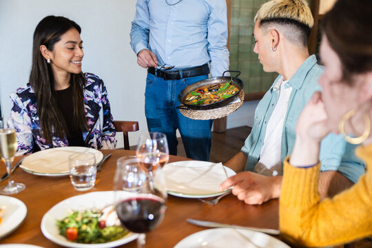 Friends enjoying Mediterranean dining in modern restaurant