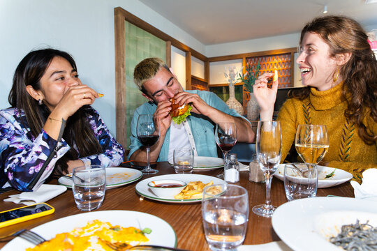 Friends enjoying dinner and drinks together at a restaurant