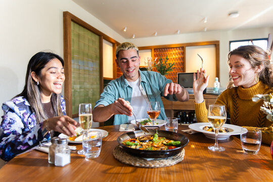 Friends sharing Mediterranean food in a cozy restaurant