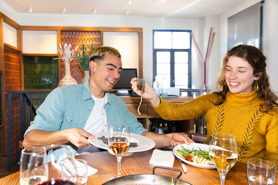 Friends sharing Mediterranean dining in cozy restaurant