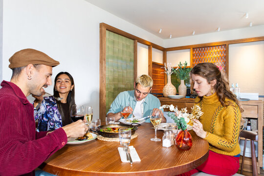 Friends sharing Mediterranean paella at A cozy restaurant