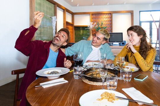 Friends sharing Mediterranean food at restaurant table