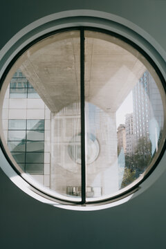 Modern city architecture framed through circular window view