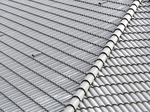 Grey tiled roof ridge detail with repeating tile pattern
