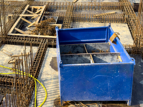 Construction site with steel rebar and blue material box