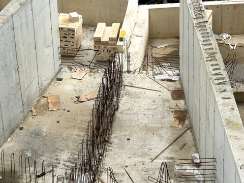 Concrete foundation trench with rebar cage on site