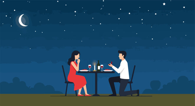 A man kneels to propose to a woman at a romantic outdoor dinner under the moon