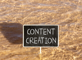 Naklejka premium Time for content creation symbol. Concept words Content creation on beautiful black blackboard. Beautiful Red sea water background. Business time for content creation concept. Copy space.